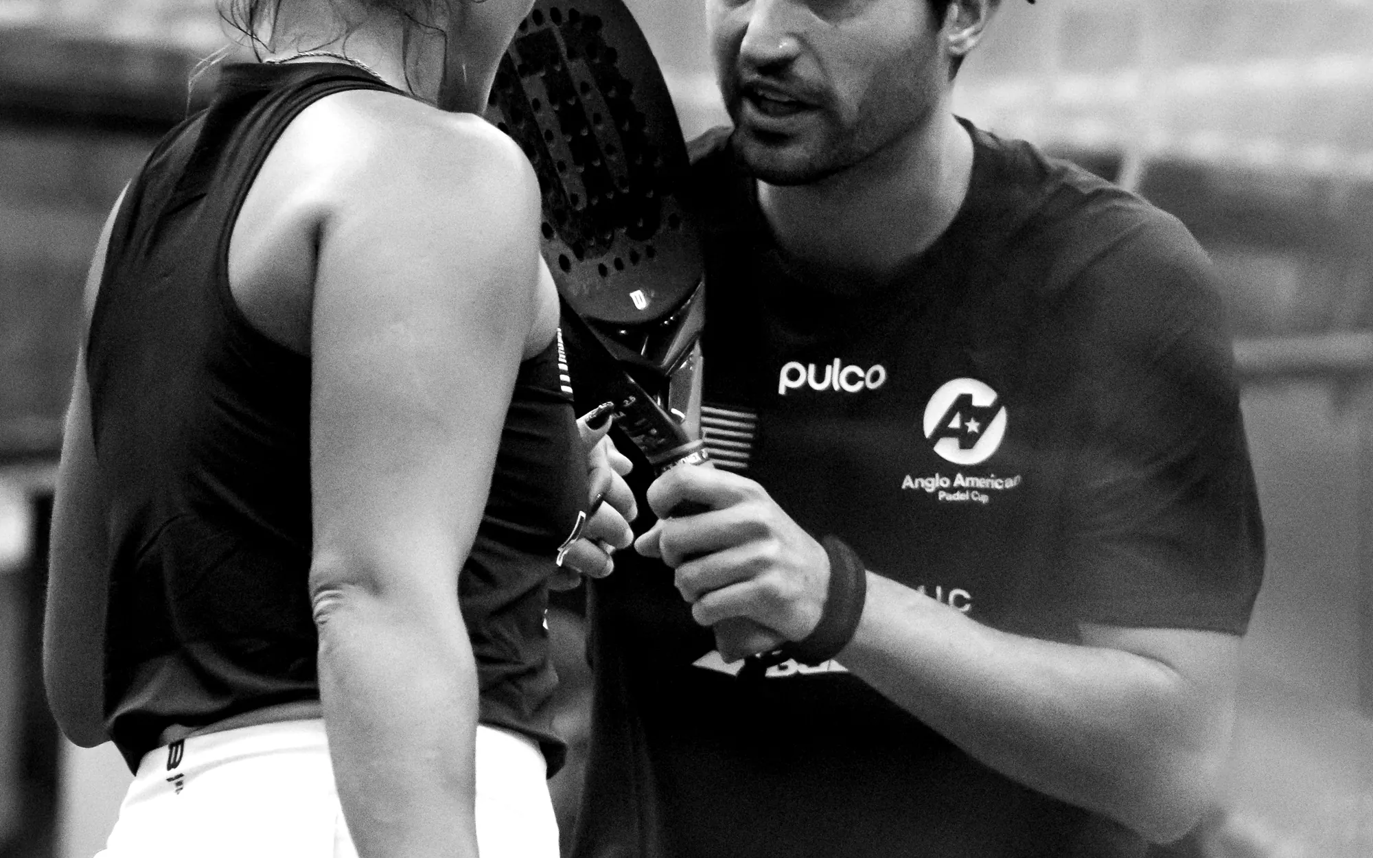 Padel players meeting at the net