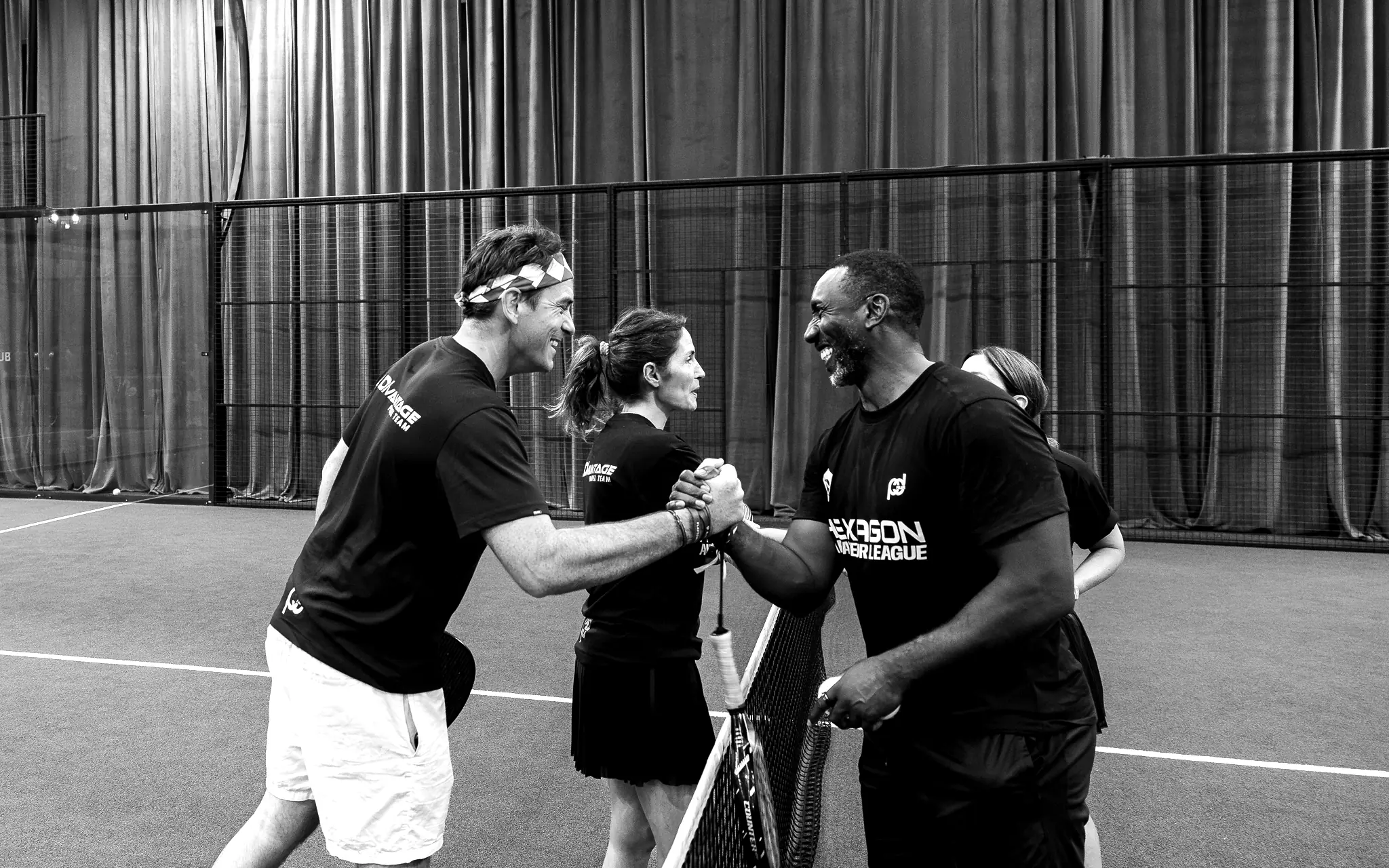 Padel club team celebrating together on court
